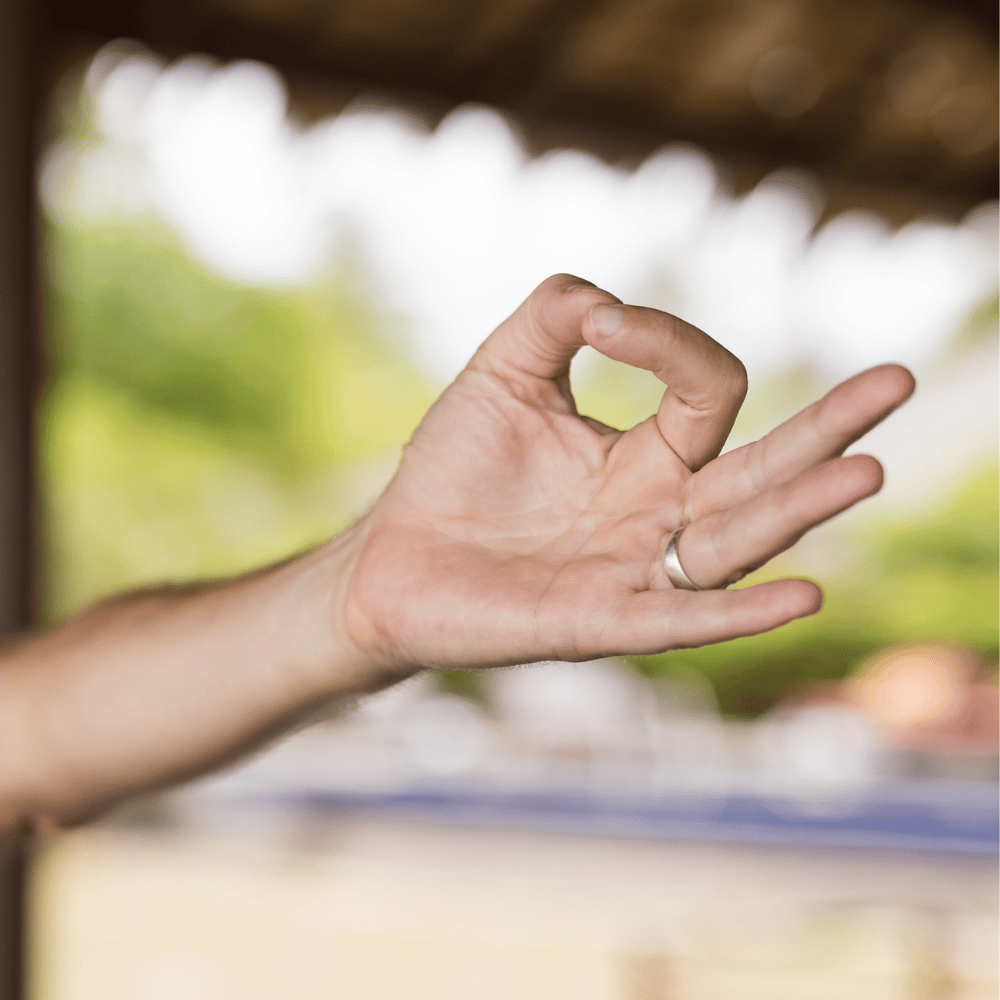 Hand making a yoga mudra in Byron Bay private home yoga session